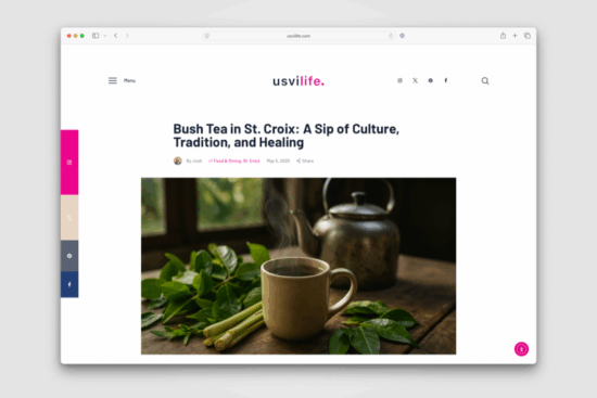 A steaming cup of bush tea on a wooden table surrounded by fresh green leaves and lemongrass, with a rustic kettle in the background.